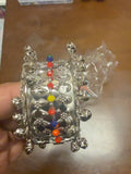 Silver tone bangle with bells and colorful beads